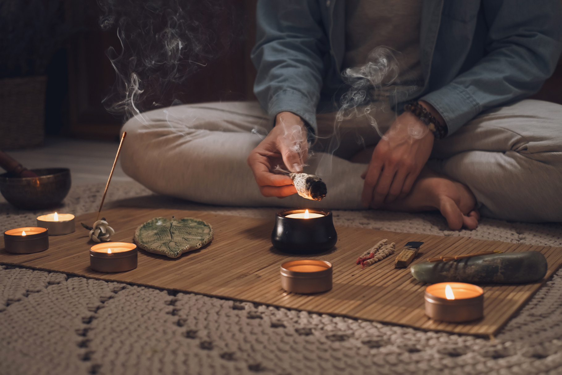 Man lighting incense for meditation and spiritual practice